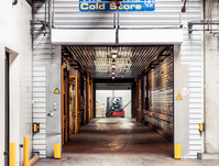 The front of the cold store warehouse in Riga. The gate is open and forklift can be seen in the background.