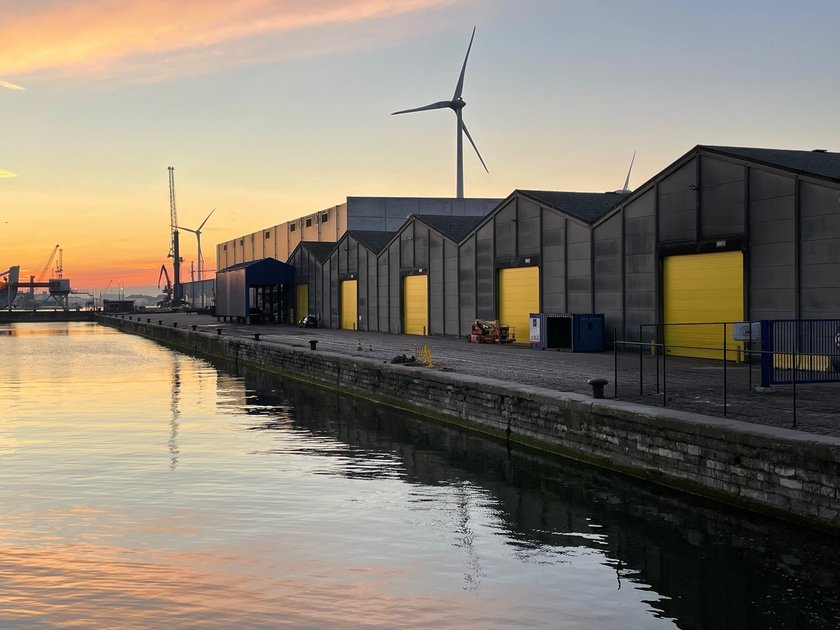 Yellow waterfront warehouse gates with windbreaks in the background