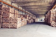 [Translate to Deutsch:] A coffee warehouse from inside. Bags are stapled left and right.