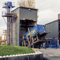 A Vollers container is tilted to be emptied