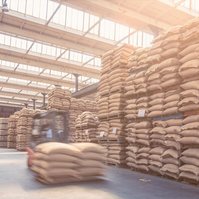 [Translate to Deutsch:] Glimpse into a warehouse with coffee bags